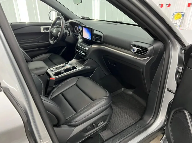 The interior of a ford explorer is shown with the door open.