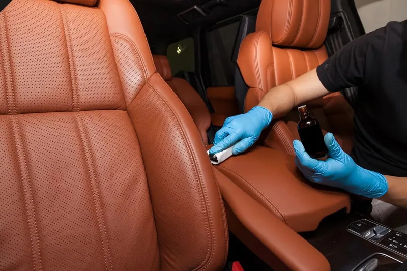 Leather seat being treated during interior detailing