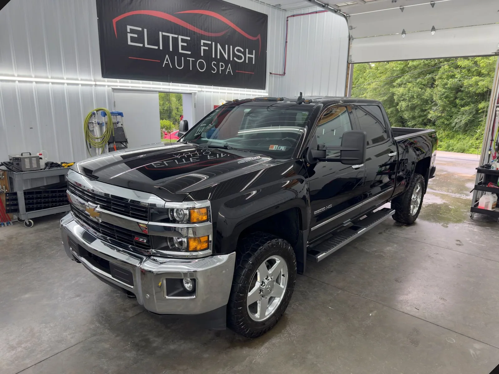 Black Chevrolet Silverado in the Elite Finish Auto Spa shop