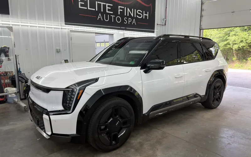 A white Kia EV9 with window tint in the Elite Finish shop